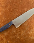 Knife with a blue handle on a brown surface