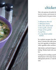 Purple bowl of chicken and gnocchi soup on a wooden surface with a recipe card next to it.