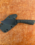 Black knife with sheath on a brown textured surface Uinta