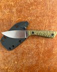 Knife with a black sheath on a brown surface Uinta