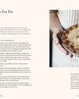 Book page with a recipe for homemade chicken pot pie and an image of a person holding a pie.