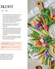 Vegetable platter with dip in the center, surrounded by text on a magazine page.