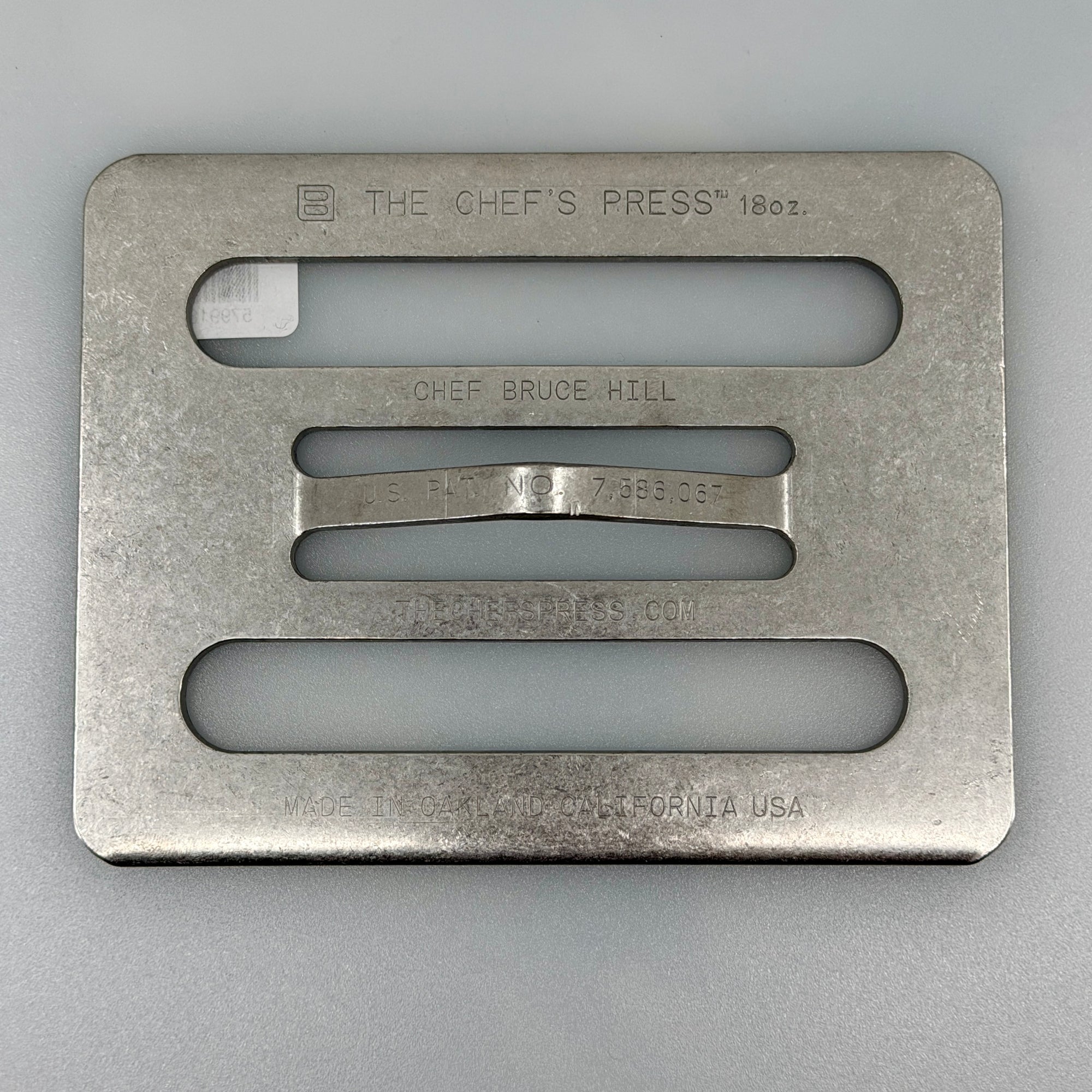 The Chef’s Press 18 oz stainless cooking press on kitchen counter