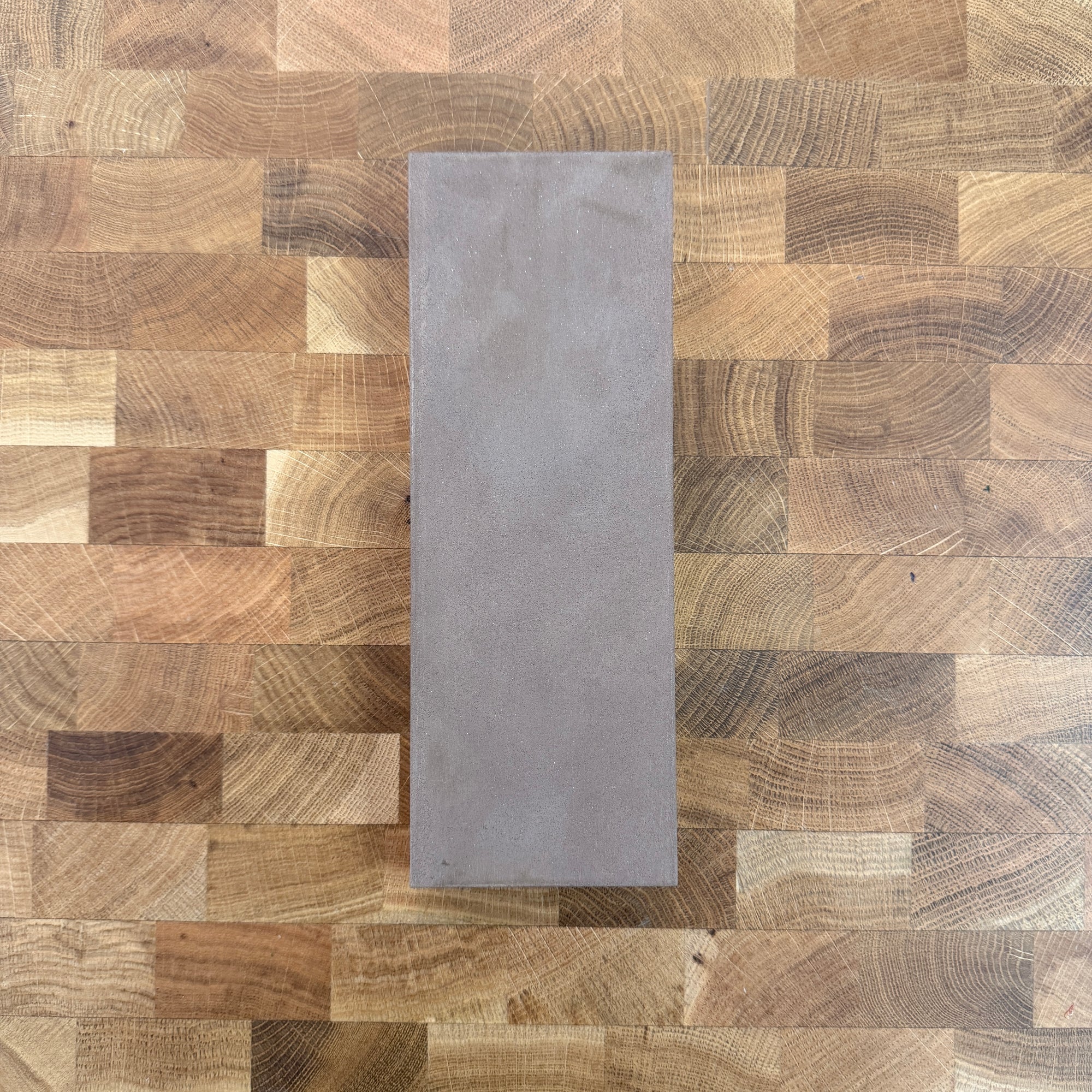 A diamond resin stone on a wood table top
