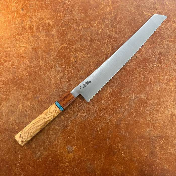 Serrated bread knife with wooden handle on a brown surface