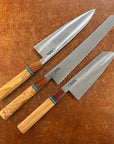 Three knives with wooden handles on a brown surface a gyuto, a bread, a bunker