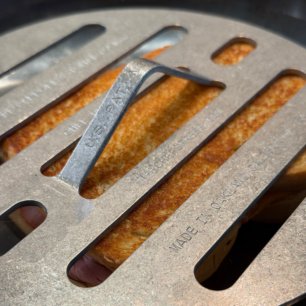 Grilling a grilled cheese under Chef’s Press for great toast