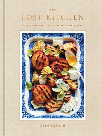Book cover of 'The Lost Kitchen' with a dish of grilled vegetables on a blue and white border.