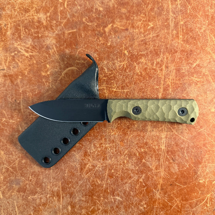 Knife with a green handle and black sheath on a brown leather background uinta
