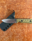 Knife with green handle and black sheath on a brown surface uinta
