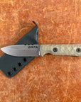 Knife with a sheath on a brown leather background uinta
