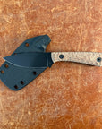 Knife with a sheath on a brown textured surface  Uinta