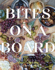 Book cover of 'Bites on a Board' with food items on a wooden board.