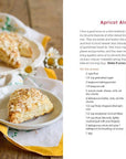 Scones with apricot jam on a wooden table, accompanied by a recipe card.